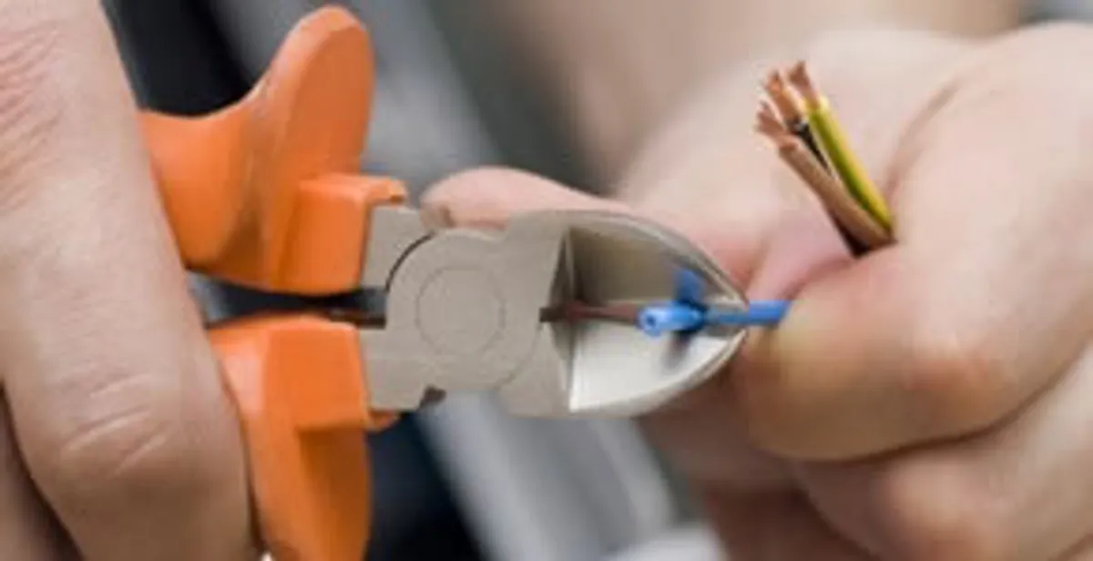 professional electrical services showing precise wire cutting by licensed electricians in Richmond, VA